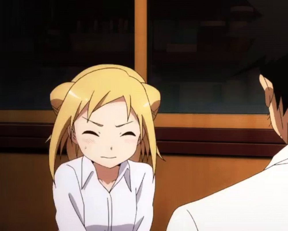 a girl with blonde hair is smiling and looking at a man in a white shirt