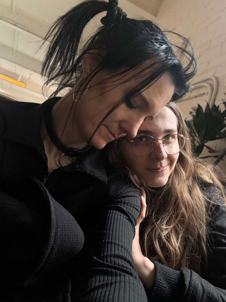 Alice and I leaning against each other at The Metrograph. Her eyes are closed and I look up at her in love and admiration. 
