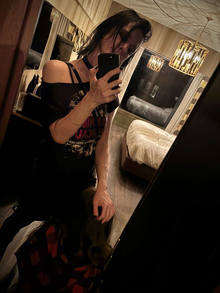 Alice takes a confident mirror selfie, her hand resting on top of my head as I face away from the mirror.