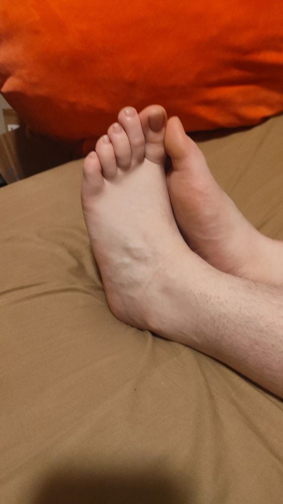 A pair of feet on a bed