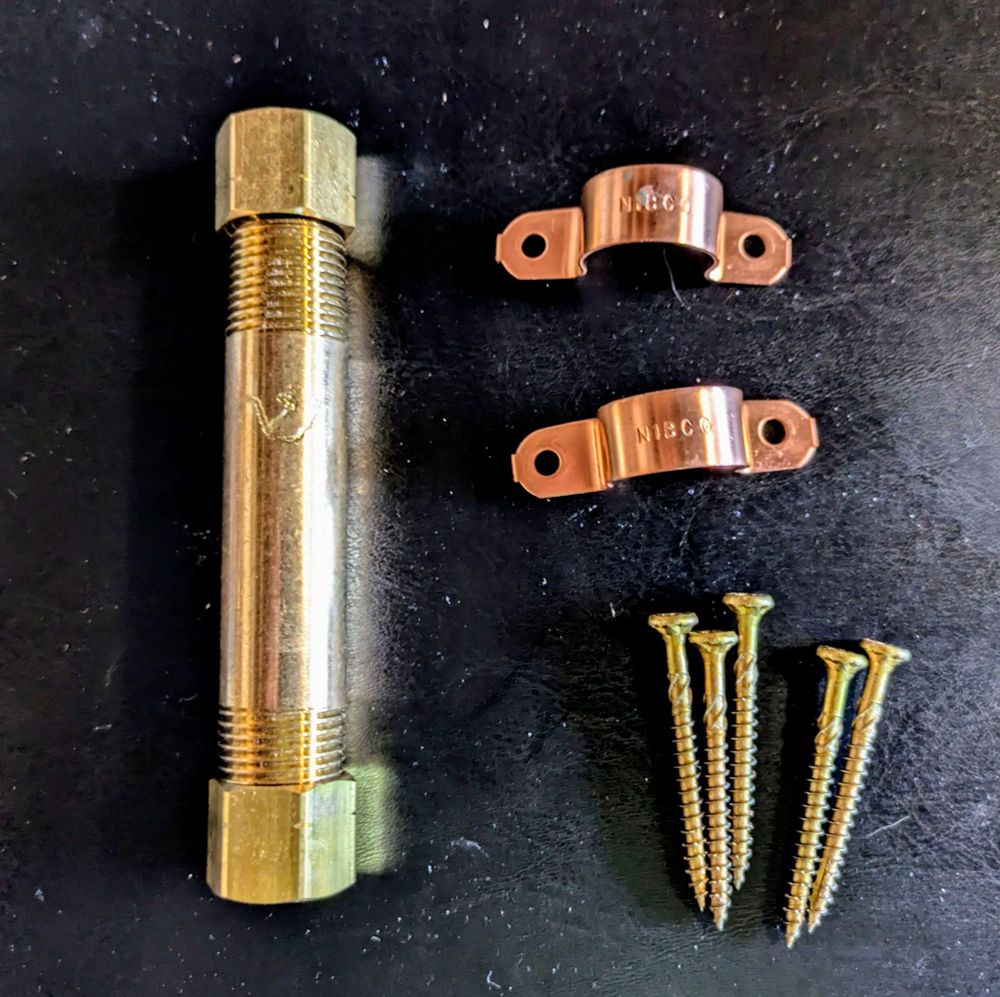A disassembled metal mezuzah. Surprisingly shiny. Picture somewhat color corrected.