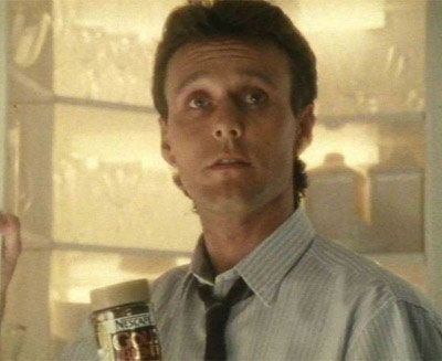 A young Anthony Head holding a jar of Nescafe instant coffee