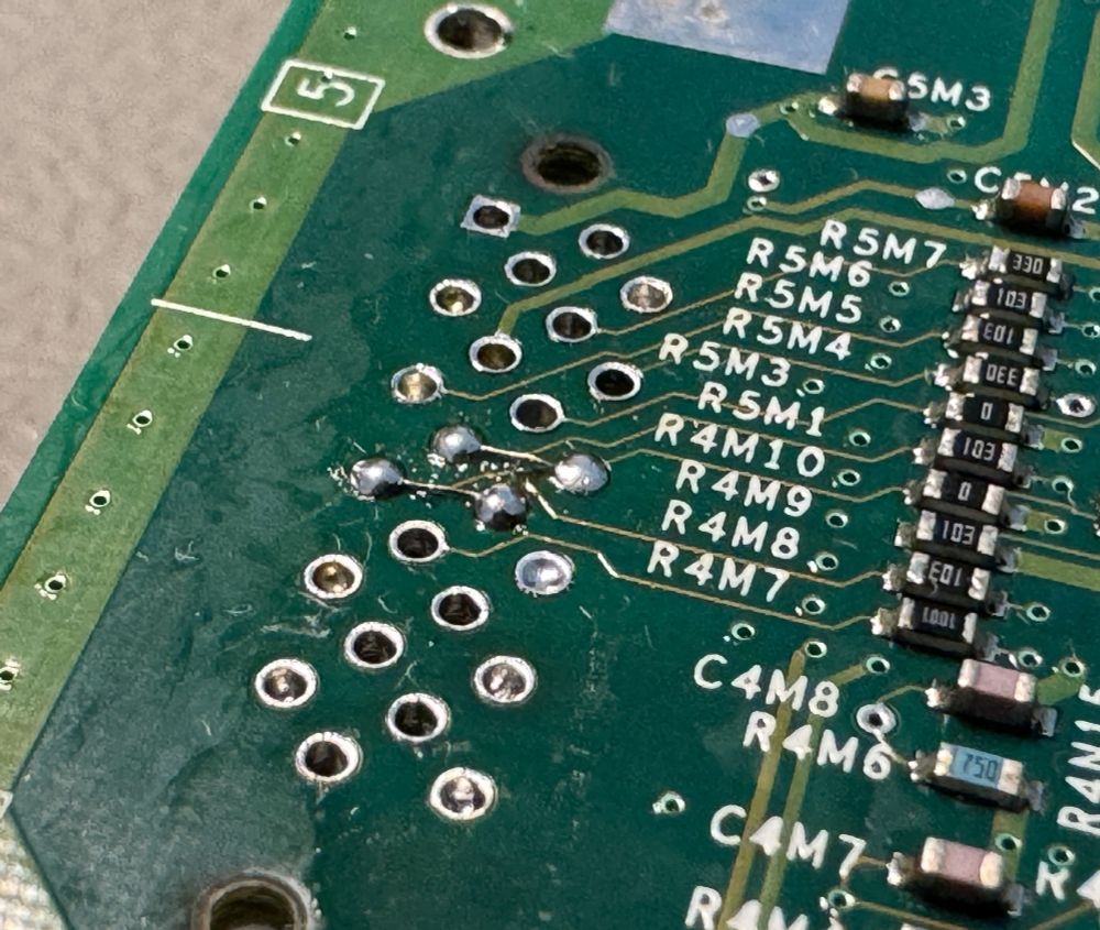 Solder jumpers on removed AV port. Back of motherboard.
