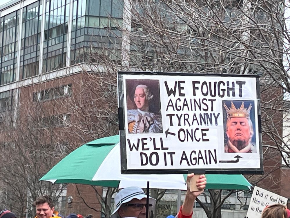 Sign reading “we found against tyranny once, we’ll do it again”