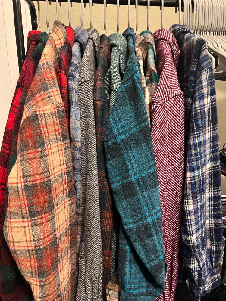 About a dozen various flannel shirts hanging on a clothes rack. Not all of them are Pendleton but probably close to half are.

Come to think of it, this is probably also missing 2-3 of my flannels