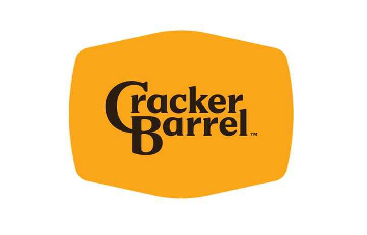 The new logo for Cracker Barrel — an orangish-yellow obloid hexagon with rounded corners, with a streamlined logotype reading “Cracker Barrel™” in dark brown in the center. 