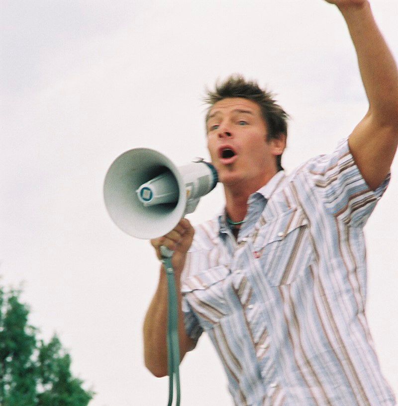man yelling into a megaphone