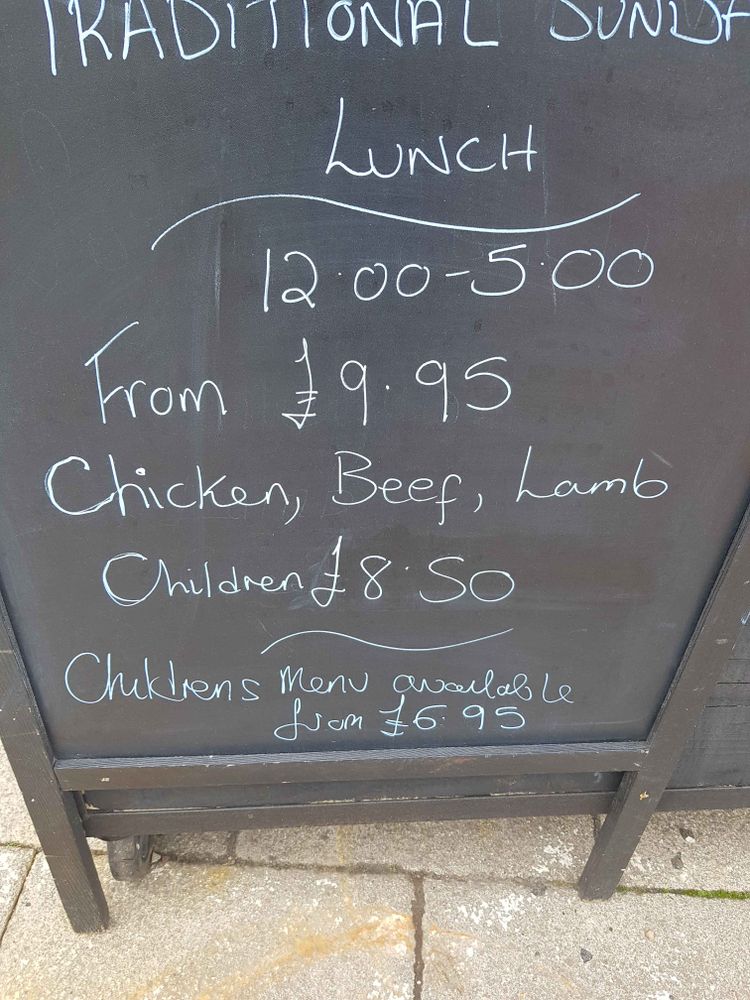 A black board sign reading
Traditional Sunday lunch reading:Chicken,  Beef, Lamb, Children £8.50