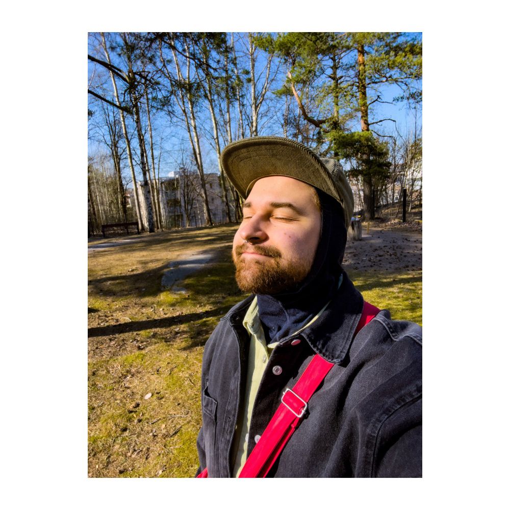 Me in a selfie next to some trees.