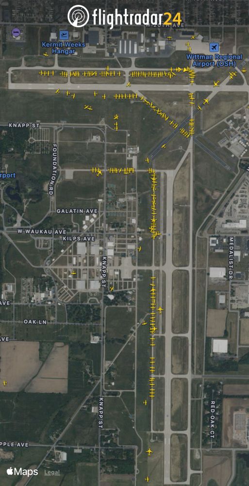 Aircraft lining the taxiways at OSH