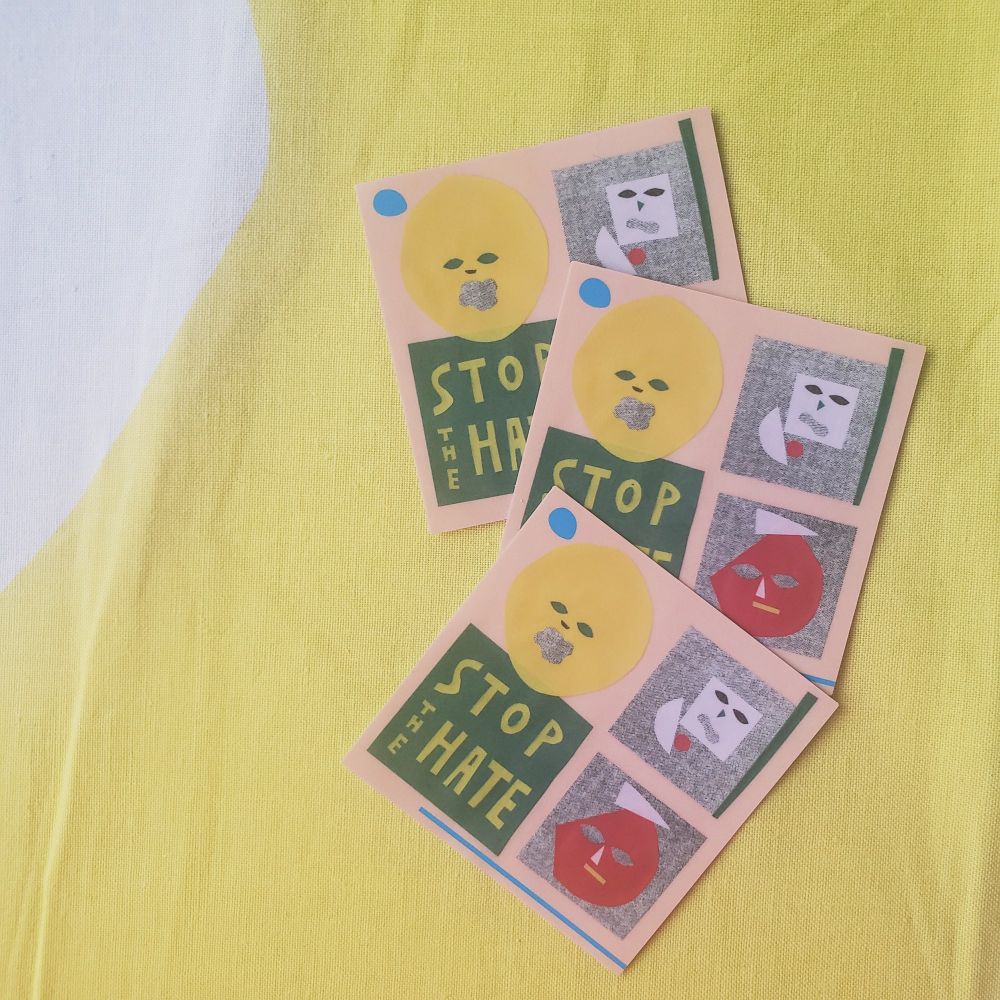 左下にSTOP THE HATEと書かれたステッカー
左上、右側上下に顔の切り絵
