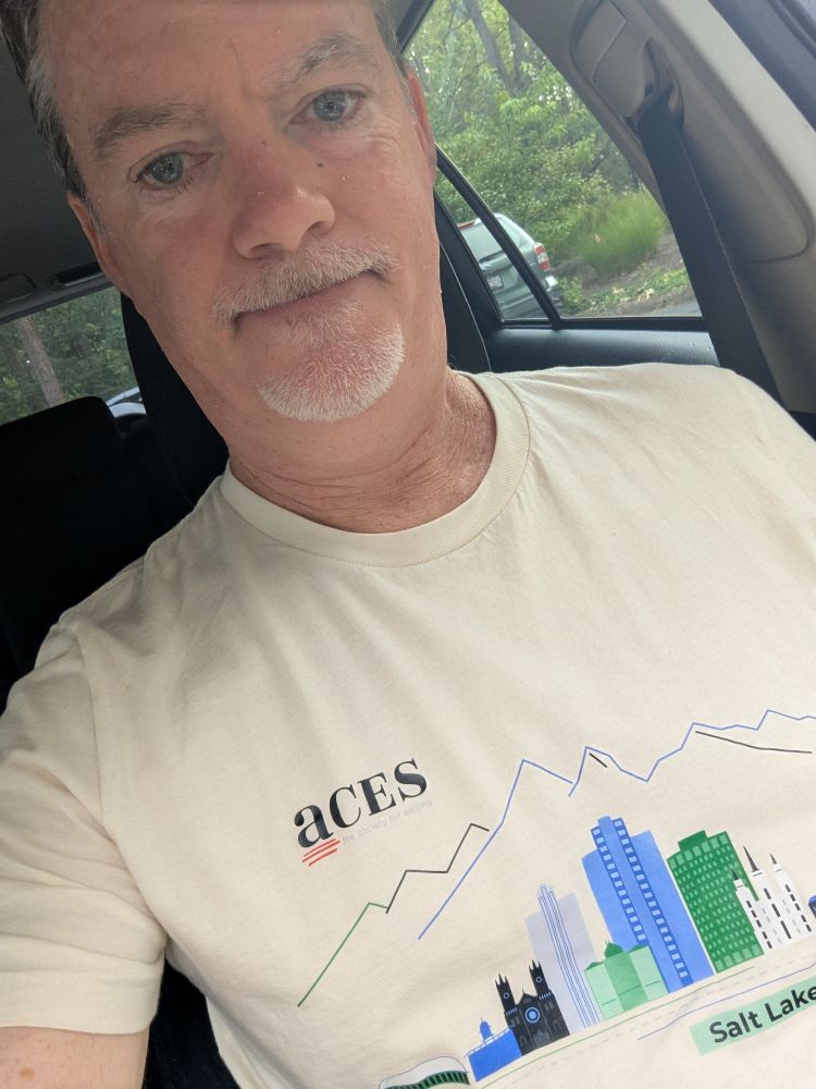 Me in my car, wearing a T-shirt with the ACES logo for their convention in Salt Lake City.
