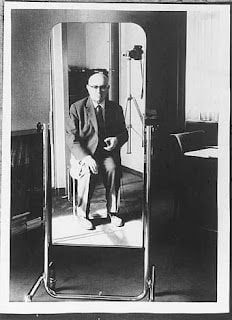 Adorno's self-portrait in mirror taken in his office, c. 1967.