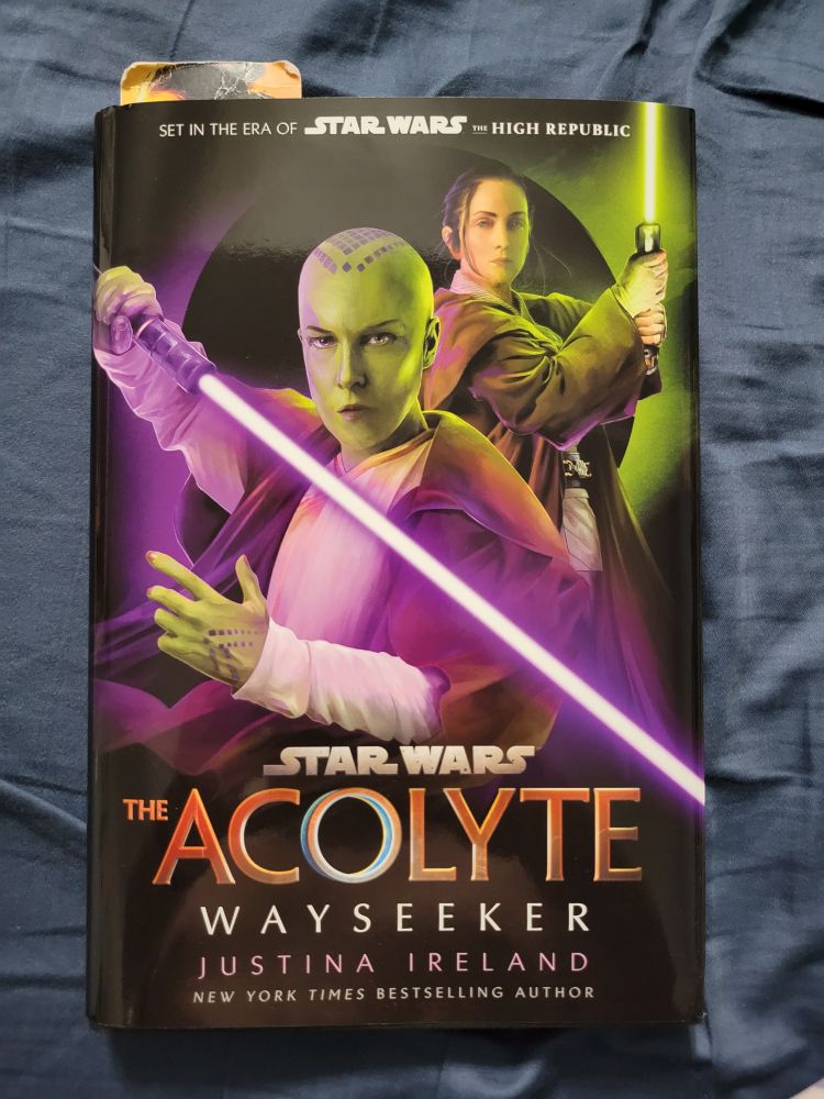 Star Wars book with two Jedi on the cover with lightsabers illuminated, vernestra Rowe in the foreground with her purple lightsaber, and indara in the background with her green lightsaber