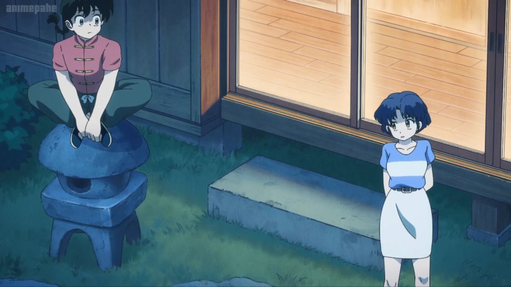 screen cap from Ranma ½ (2024)

It's evening outside the Tendo dojo/residence. Akane and Ranma both have their bodies facing away from the house, with their heads and eyes turned to look at each other. Akane is looking shy as she starts to say something. Ranma (in boy form) is sitting on top of a small statue thing holding his feet together
