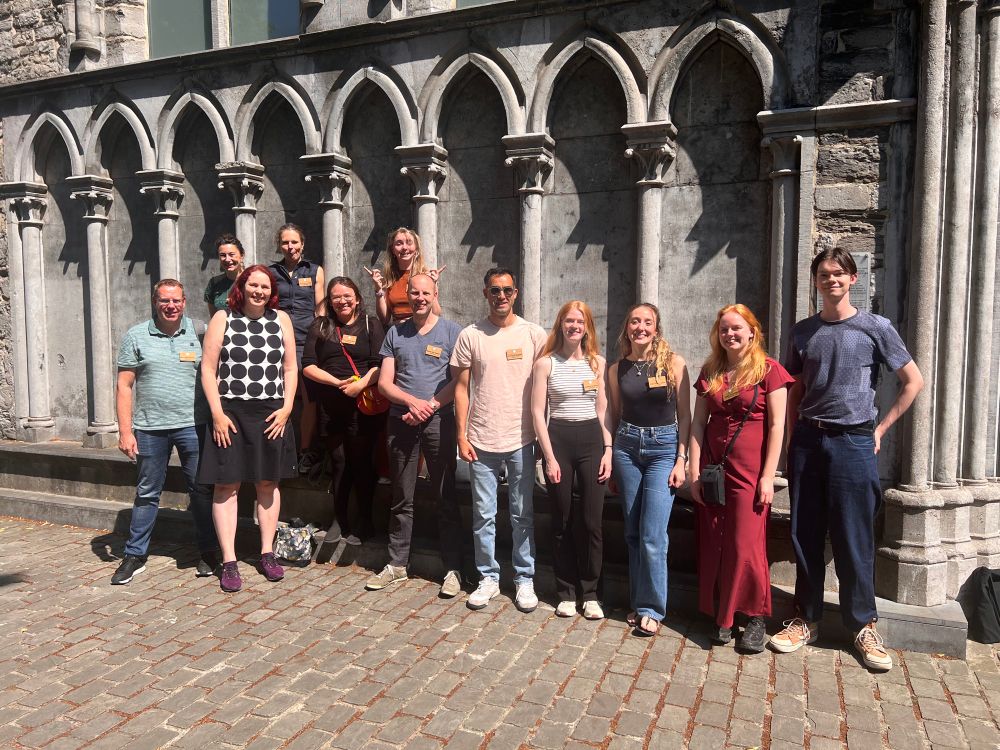 A group of 12 scientists posing in front of the conference venue of ICAR 2025.