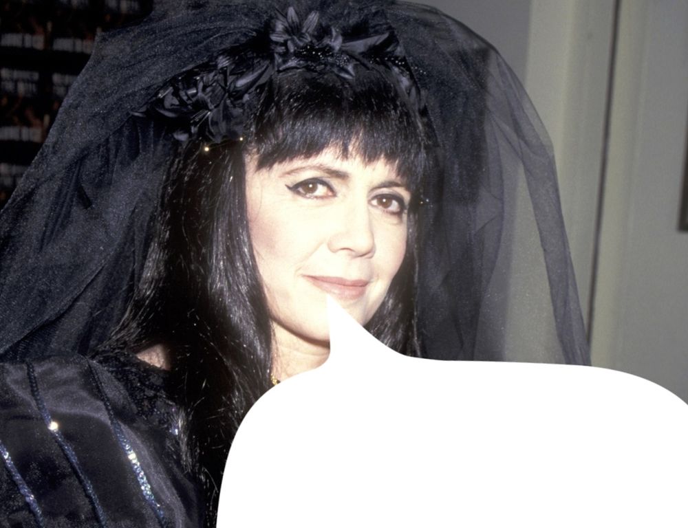 Anne Rice in her iconic black dress with an added speech bubble 