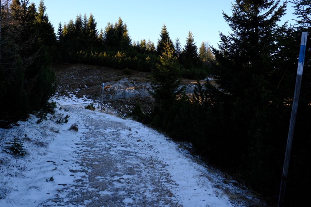 Wide path covered with a very light layer of snow.