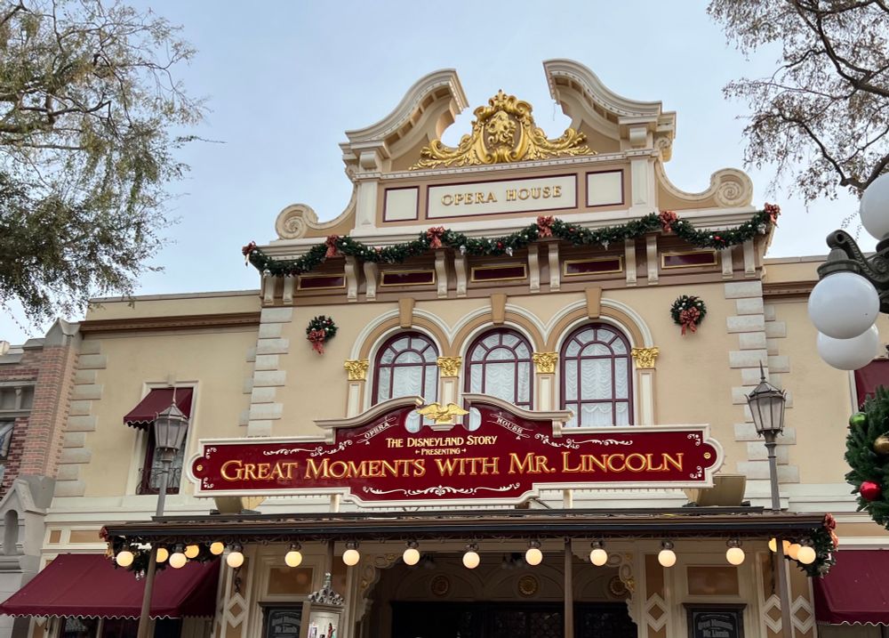 The Opera House from December 2024. The sign on the front reads "Great Moments With Mr. Lincoln". The Opera House was the first building completed while Disneyland was under construction. It is now home to the new Walt Disney - A Magical Life show, which opens today, July 17, 2025!
