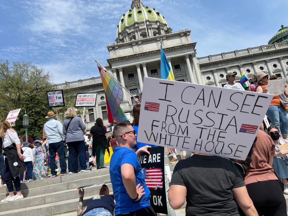 Protestor carries a sign “I can see Russia from the White House”
