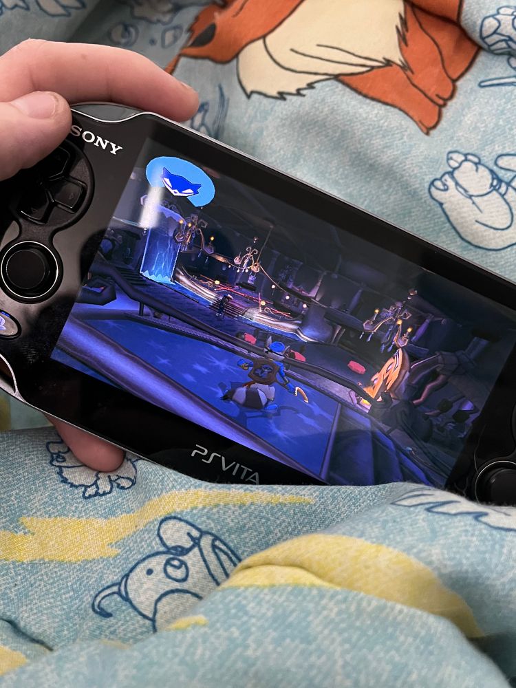 Picture of me holding my ps vita. Sly cooper is on screen seen in demetri’s club 