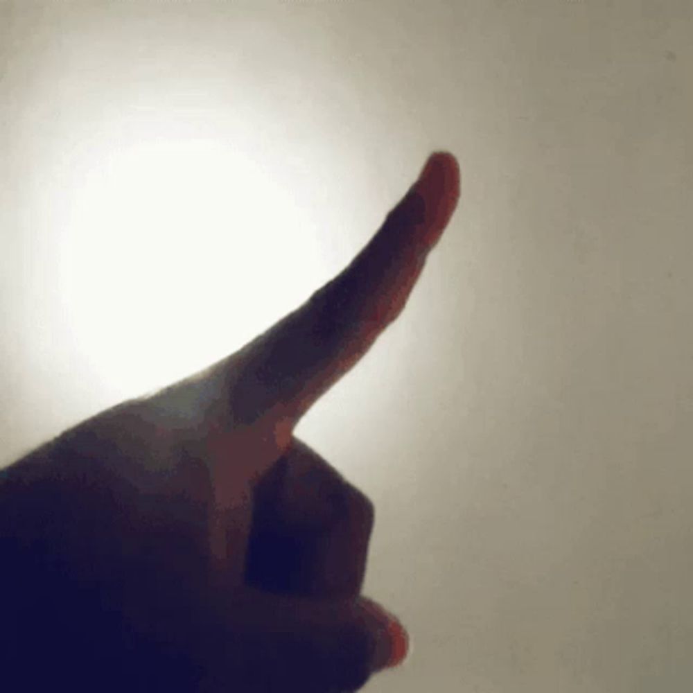 a close up of a person 's finger pointing up