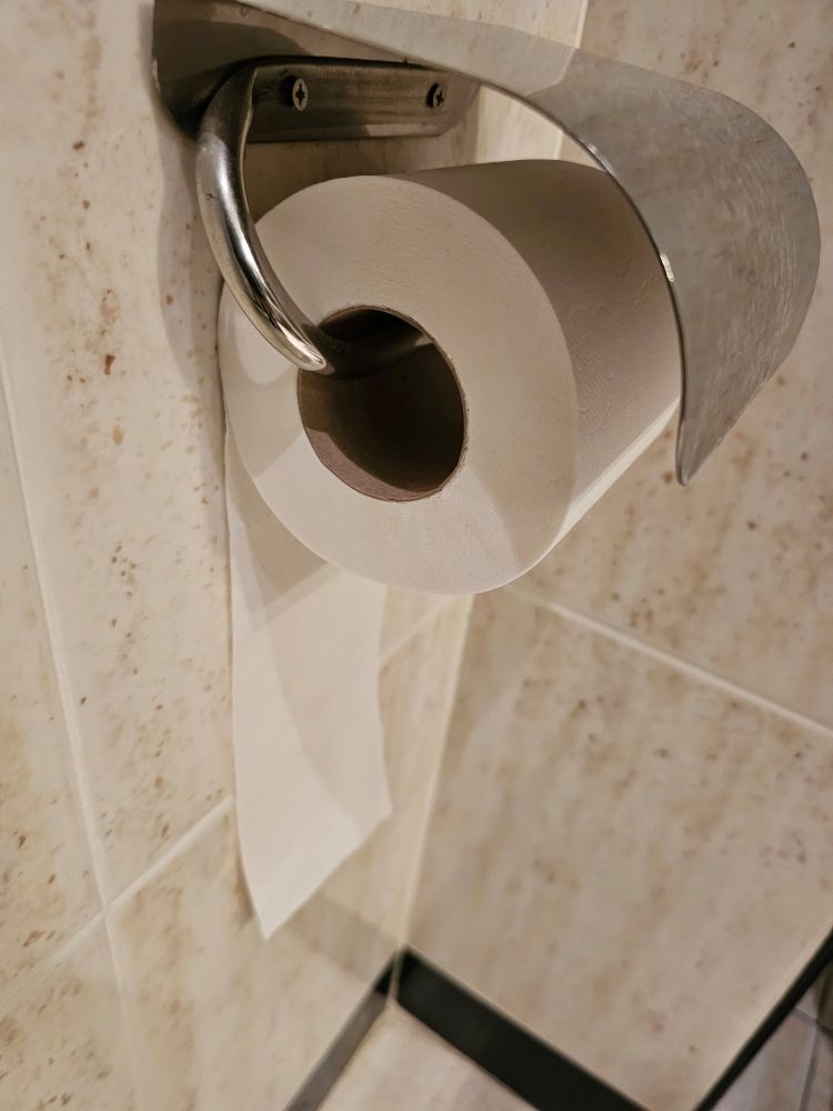 Toilet paper roll placed the wrong way round.