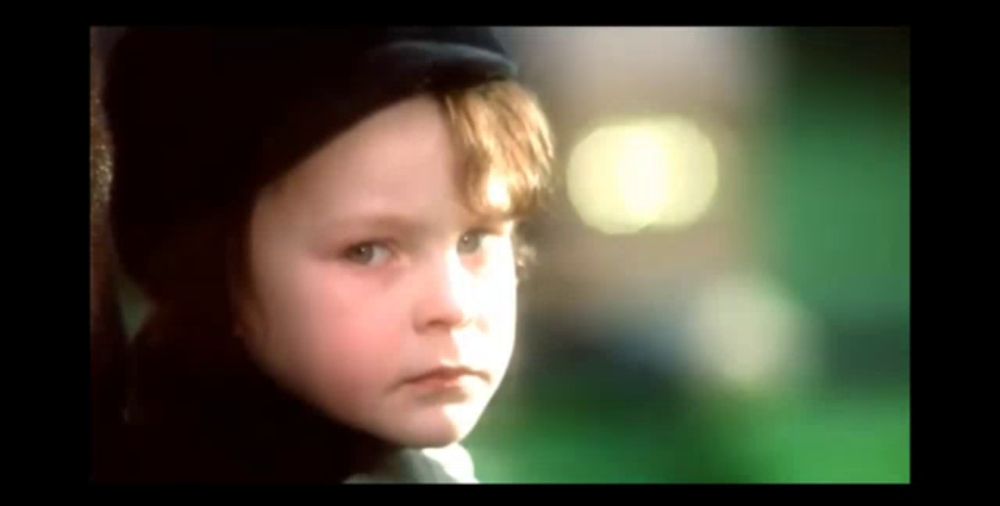 a close up of a child 's face wearing a hat