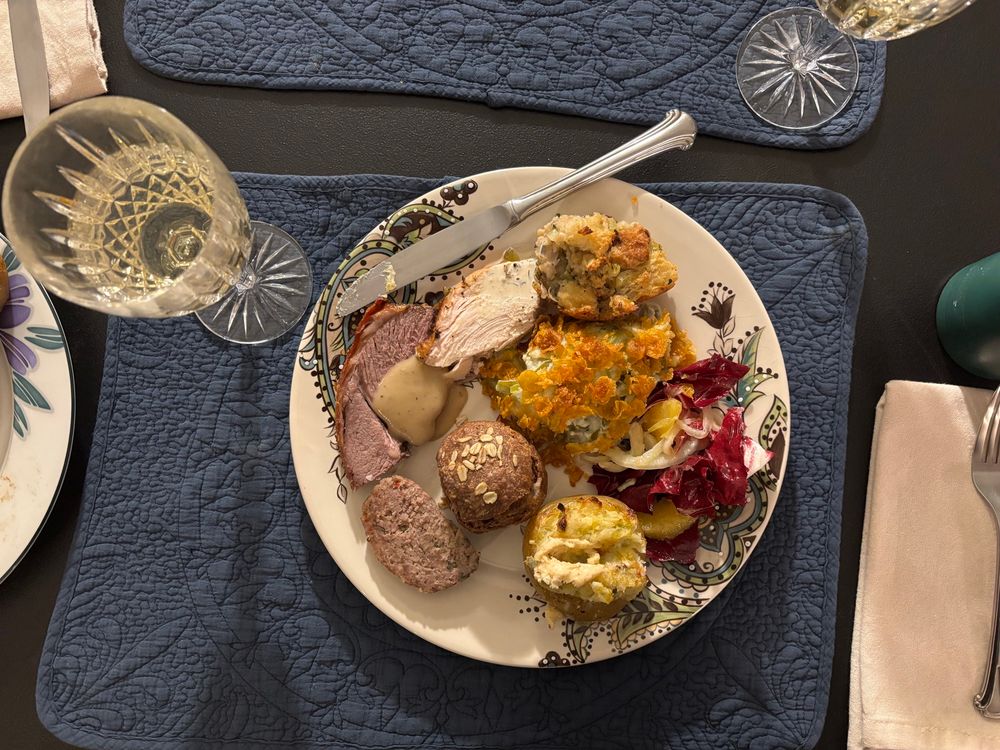 A week ne glass on the left, and a plate full of Thanksgiving food in the middle 