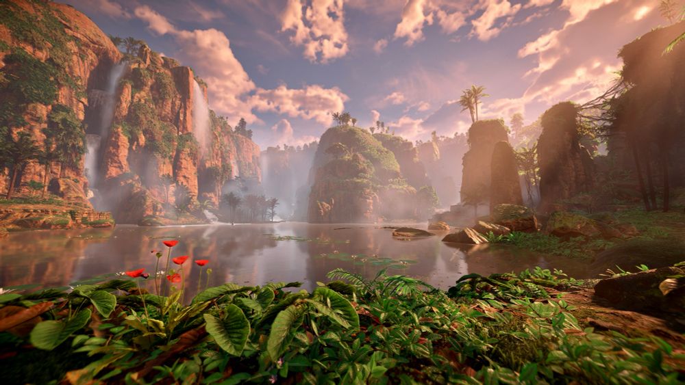 A lush scene of high cliffs, waterfalls and green plants everywhere, with a lake front and center.