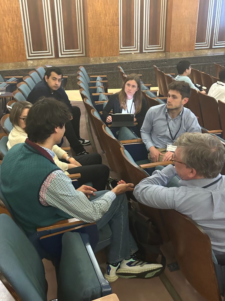 Group of six C-CAS members seated together in discussion