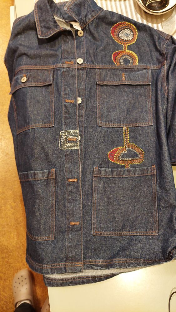 Denim jacket with bright sashiko stitch patterns