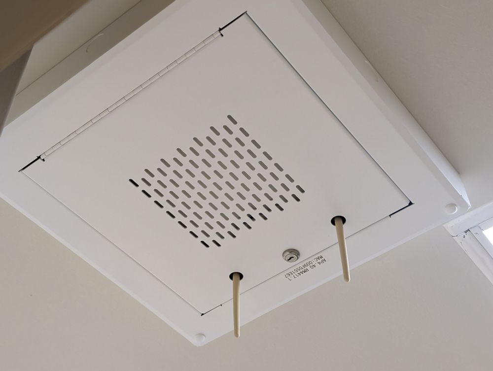 A ceiling mounted lockbox with antennas poking out