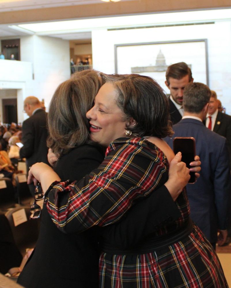 Photo of Rep. McClellan hugging Sen. Rochester.
