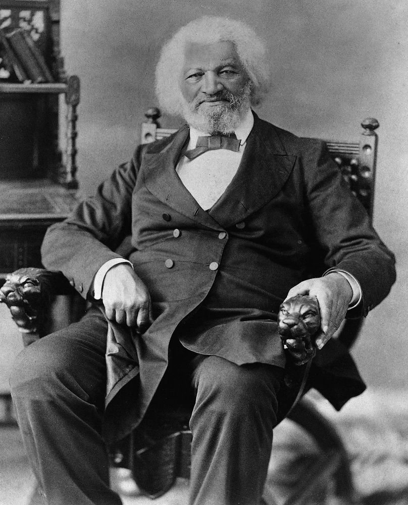 Photo of Frederick Douglass sitting in an armchair.