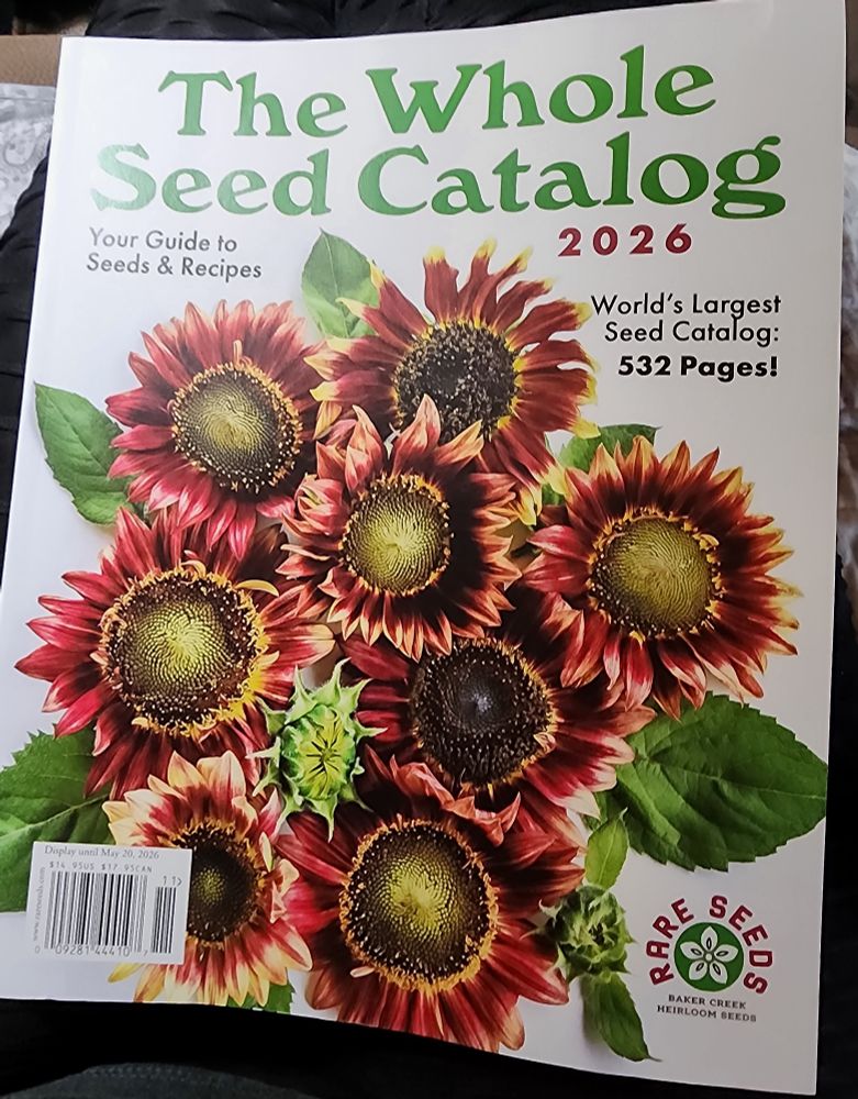 Front cover of the 2026 Baker Creek Heirloom Seeds Catalog featuring a cover photo of a bouquet of red and gold sunflowers.