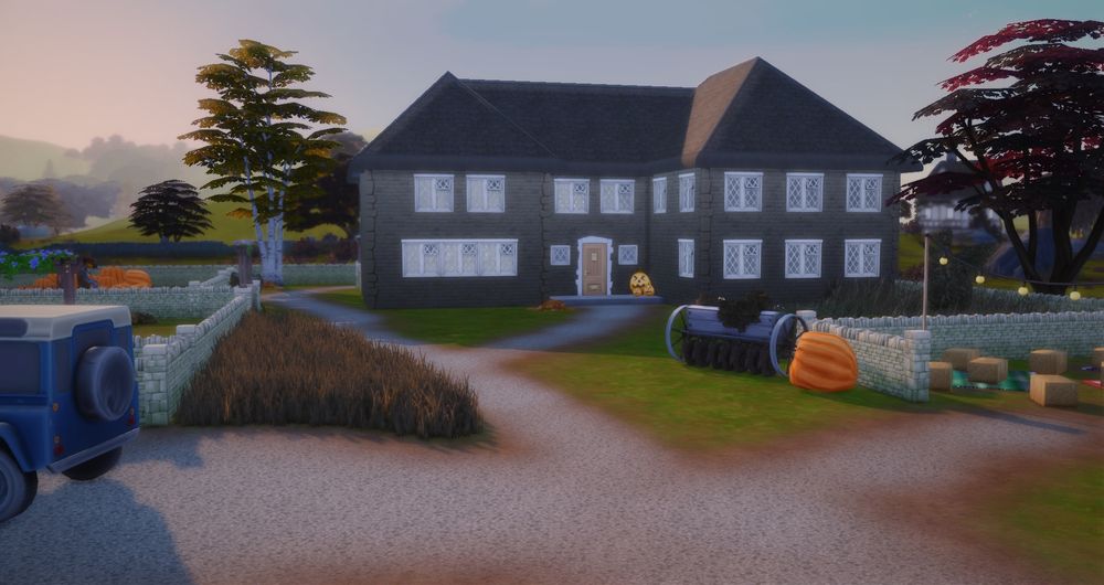 A screenshot from The Sims 4 of a WIP - there is rough terrain paint in several paths, walled in areas, a plow, a pumpkin, a farmhouse, grass and trees.