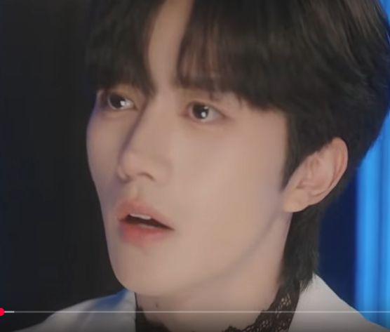 a screencap of hua yong from the series abo desire, looking sad