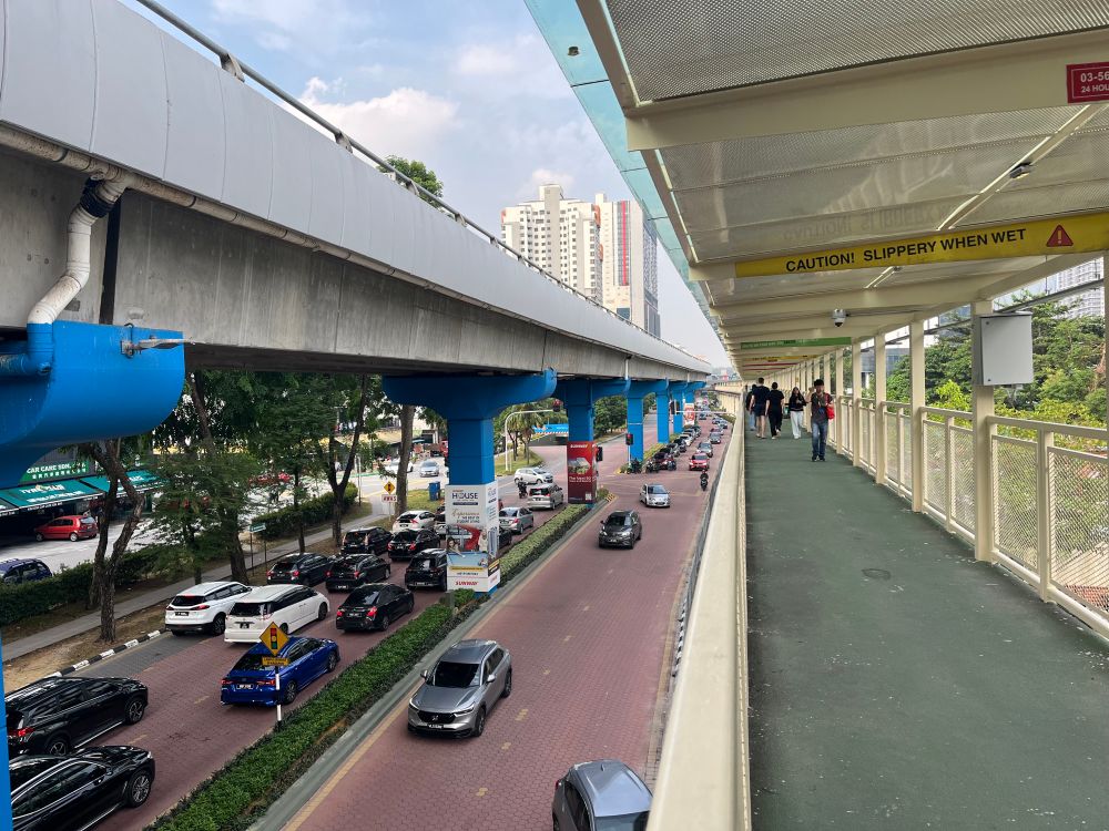 Pedestrians canopy walk and elevated busway over a busy road in Malaysia 