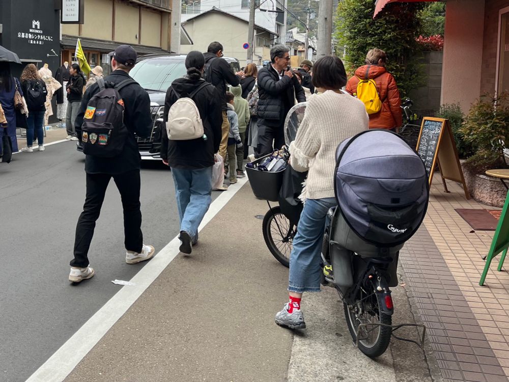 Woman on a bike with a kid seat
