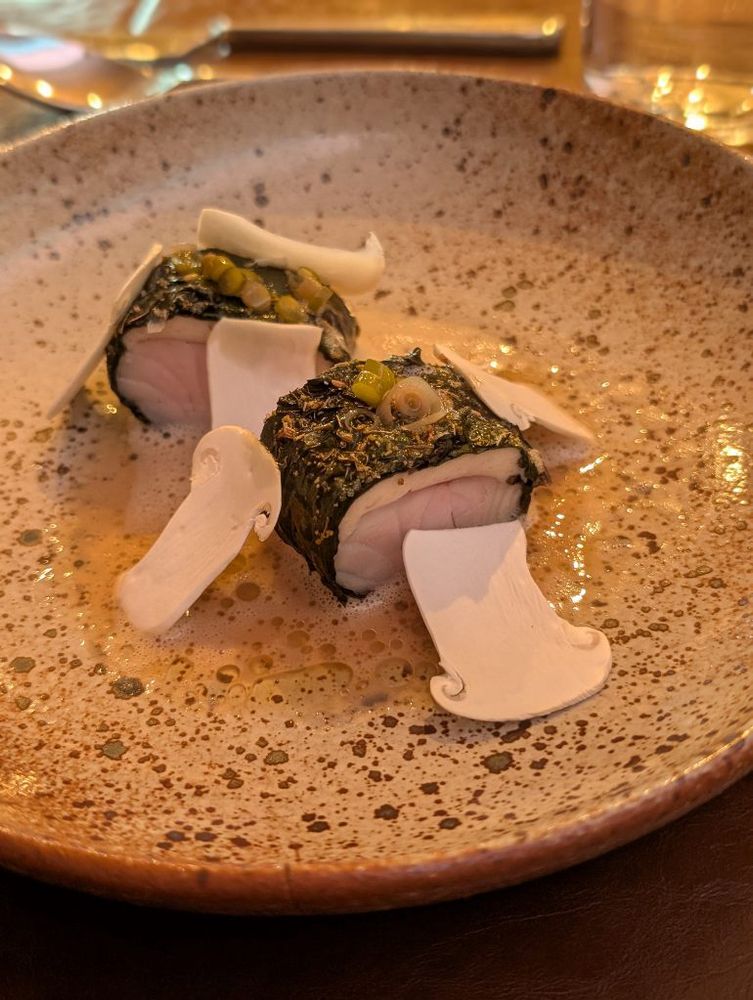 Walleye fillet and mousseline wrapped in Swiss chard with pickled green garlic, shaved matsutake mushrooms, and matsutake sauce.