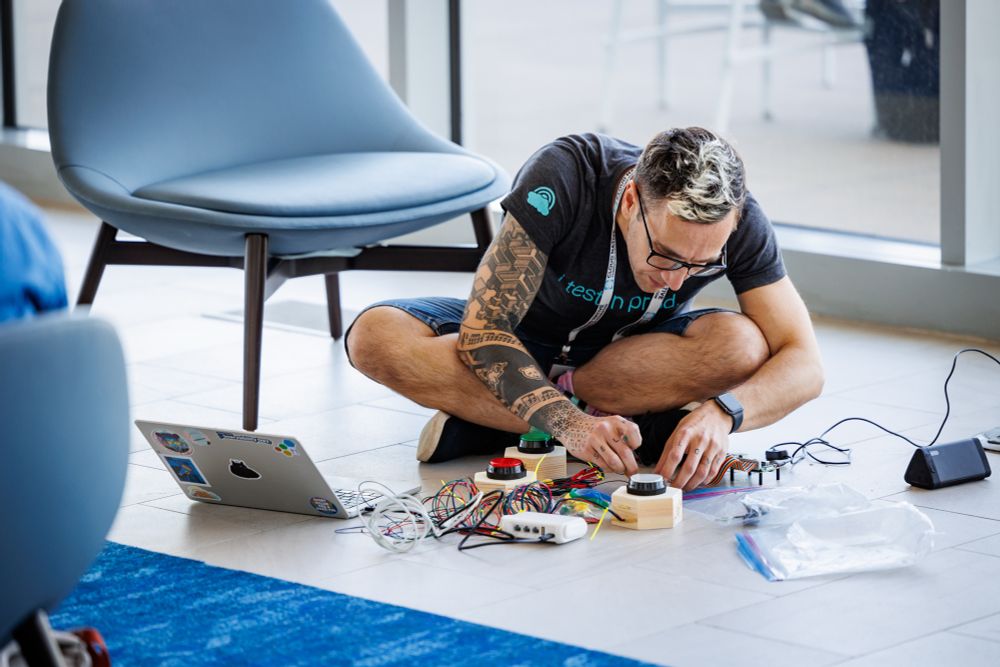 Me sitting on the denver convention centre floor hacking together buzzers for a talk