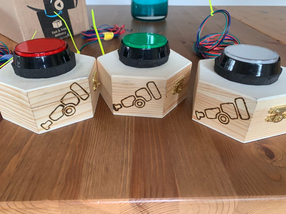 Home made game show buzzers with an Otel telescope burned into the side of their cases