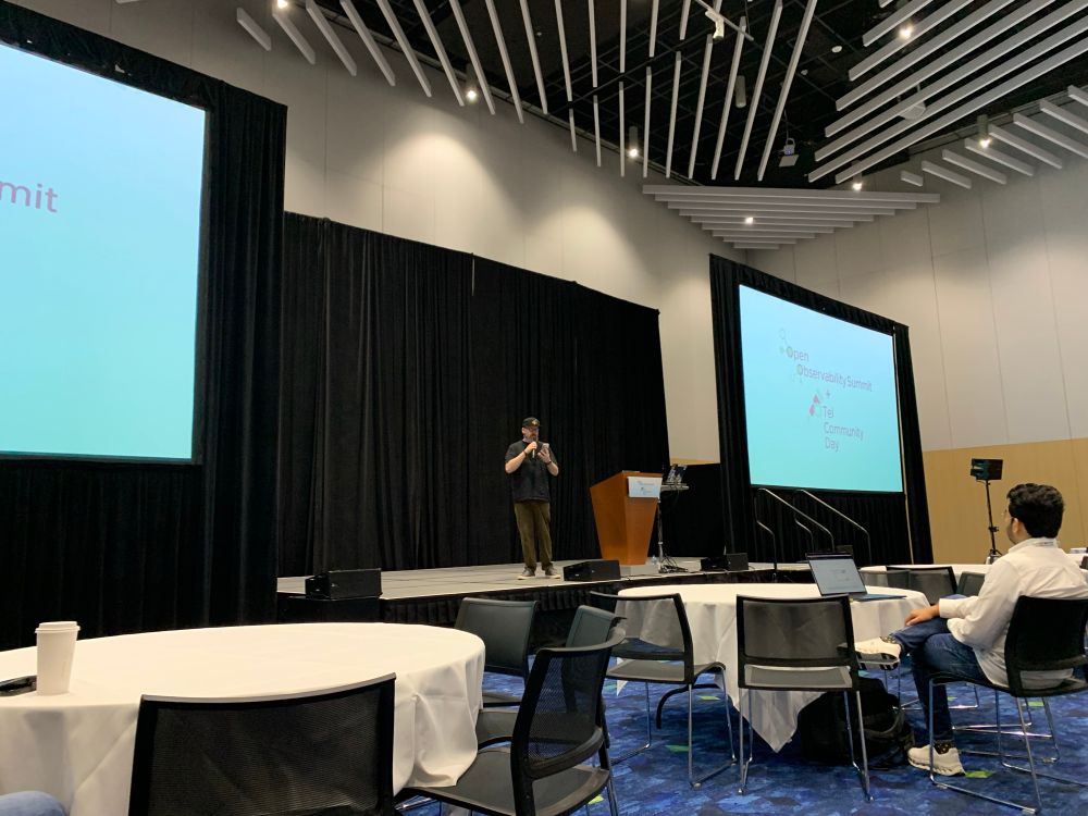 Austin on stage at the keynote for opentelemetry community day