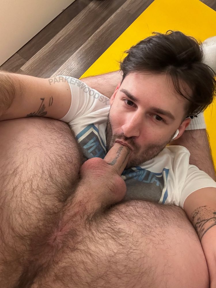 man with legs wrapped behind his head with his own cock in his mouth and his tight little hairy asshole pointed at the camera