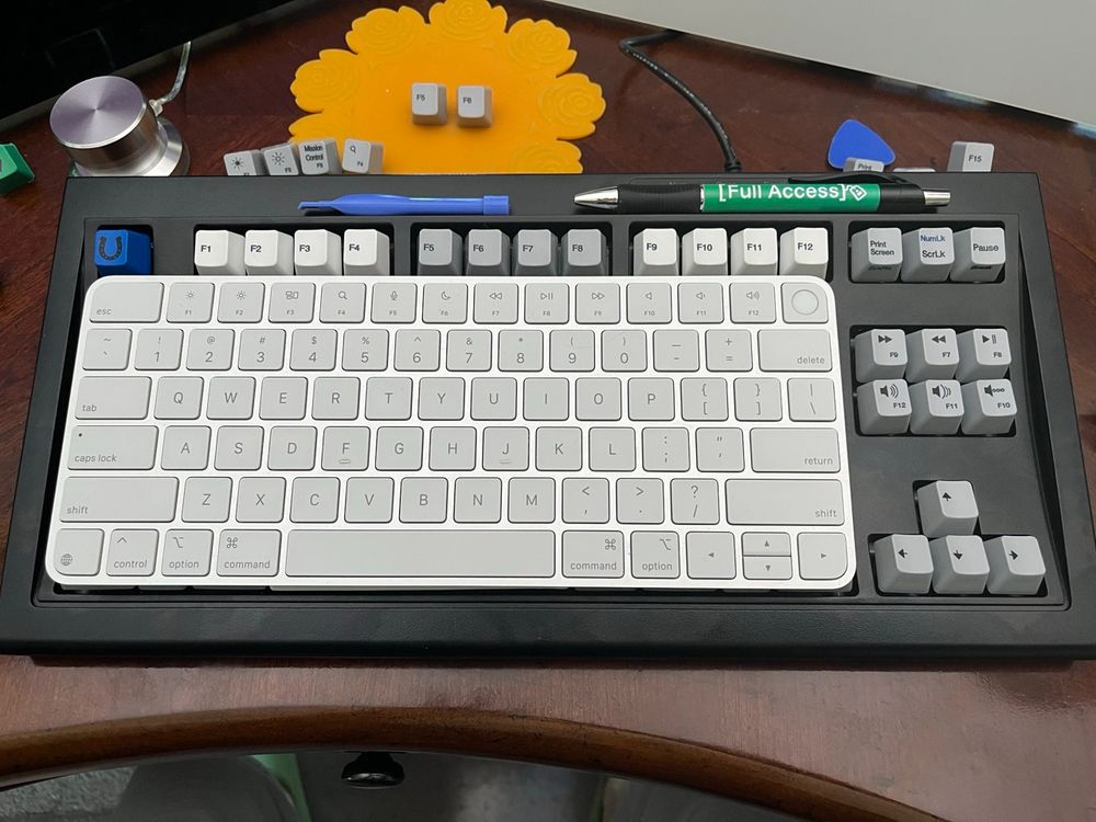 A picture of the Apple Magic Keyboard laying on the same area as the main keyboard part of the Unicomp Model M Mini keyboard. They are the same! 