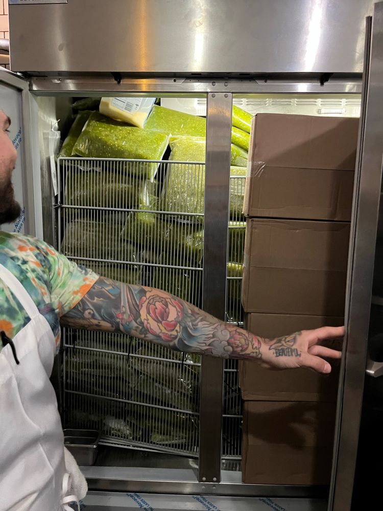 And open fridge filled with cases of Hatch Green Chile