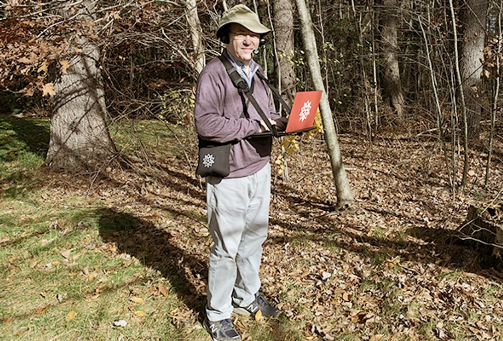 Stephen Wolfram standing  outdoors with his laptop-carrying rig