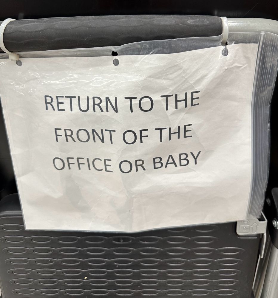Stepladder with sign "RETURN TO THE FRONT OF THE OFFICE OR BABY"