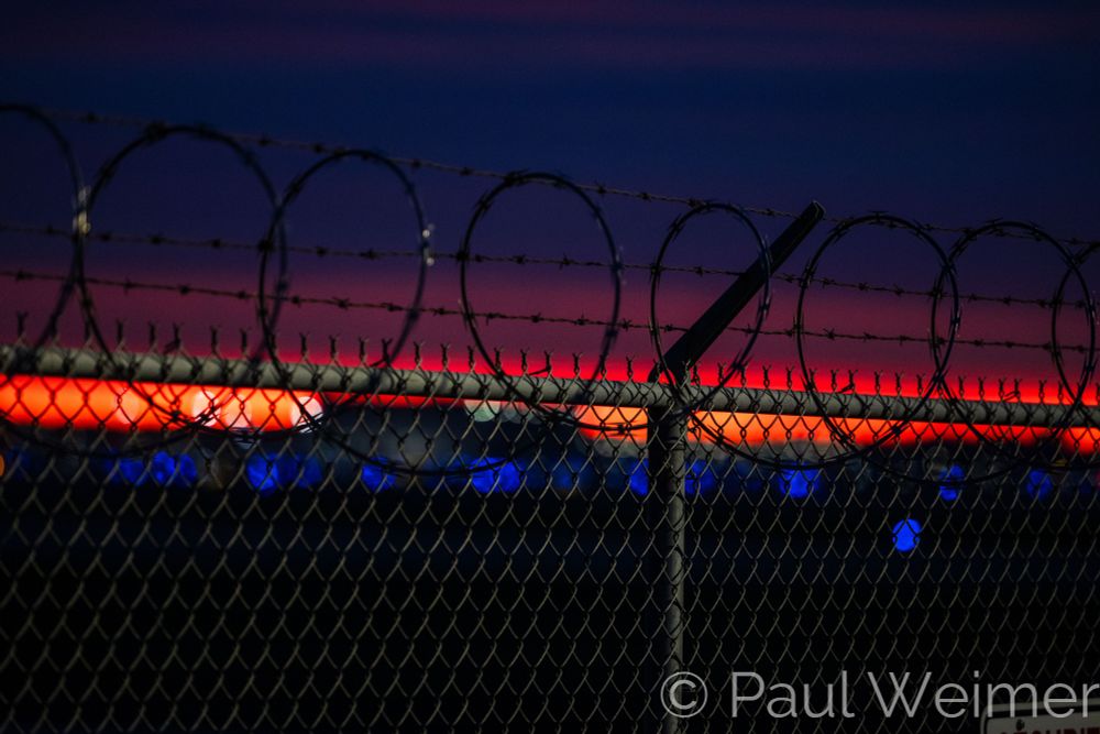 barbed wire and a line of sunrise light 